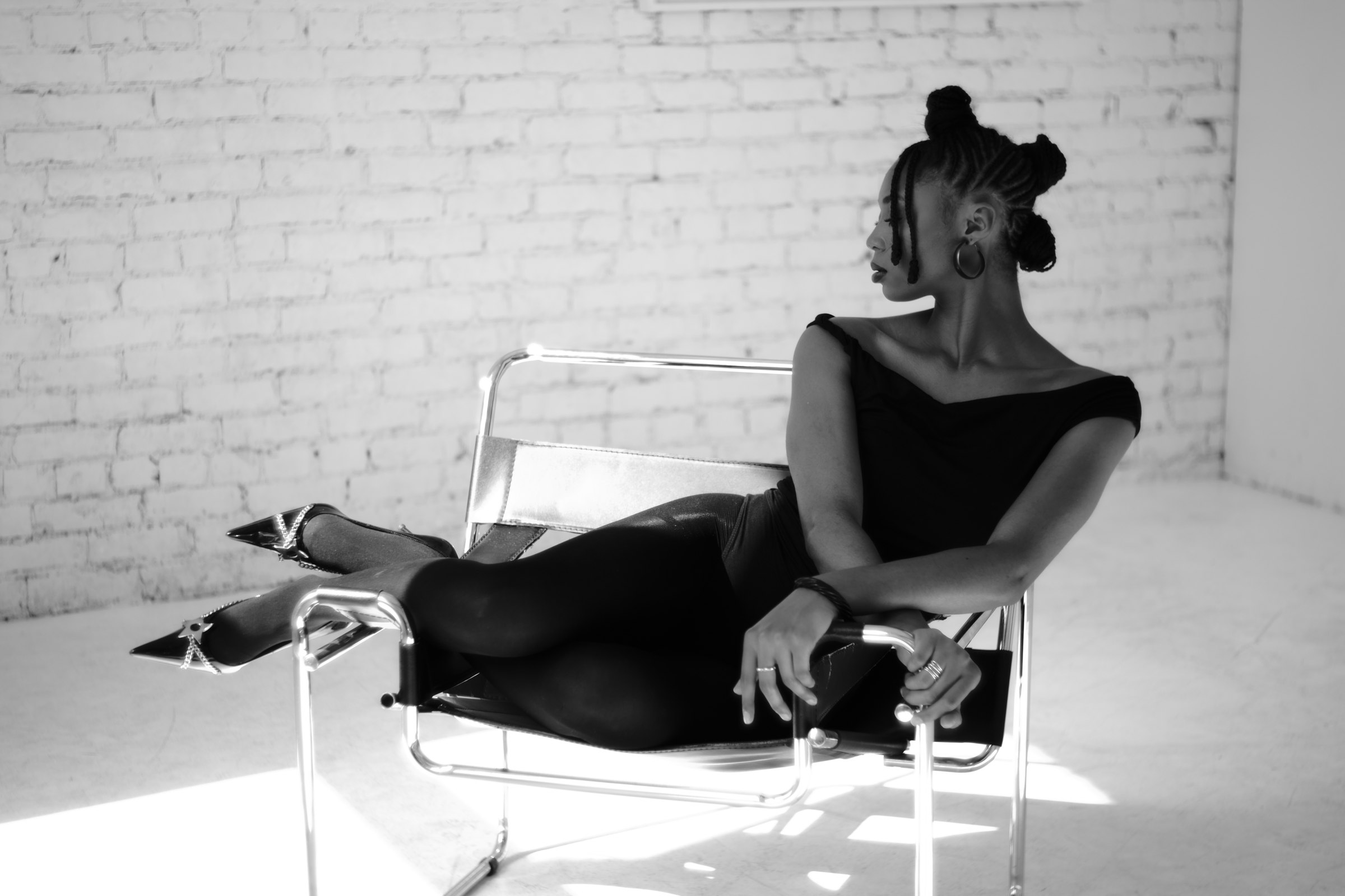 Seated studio editorial in a black dress