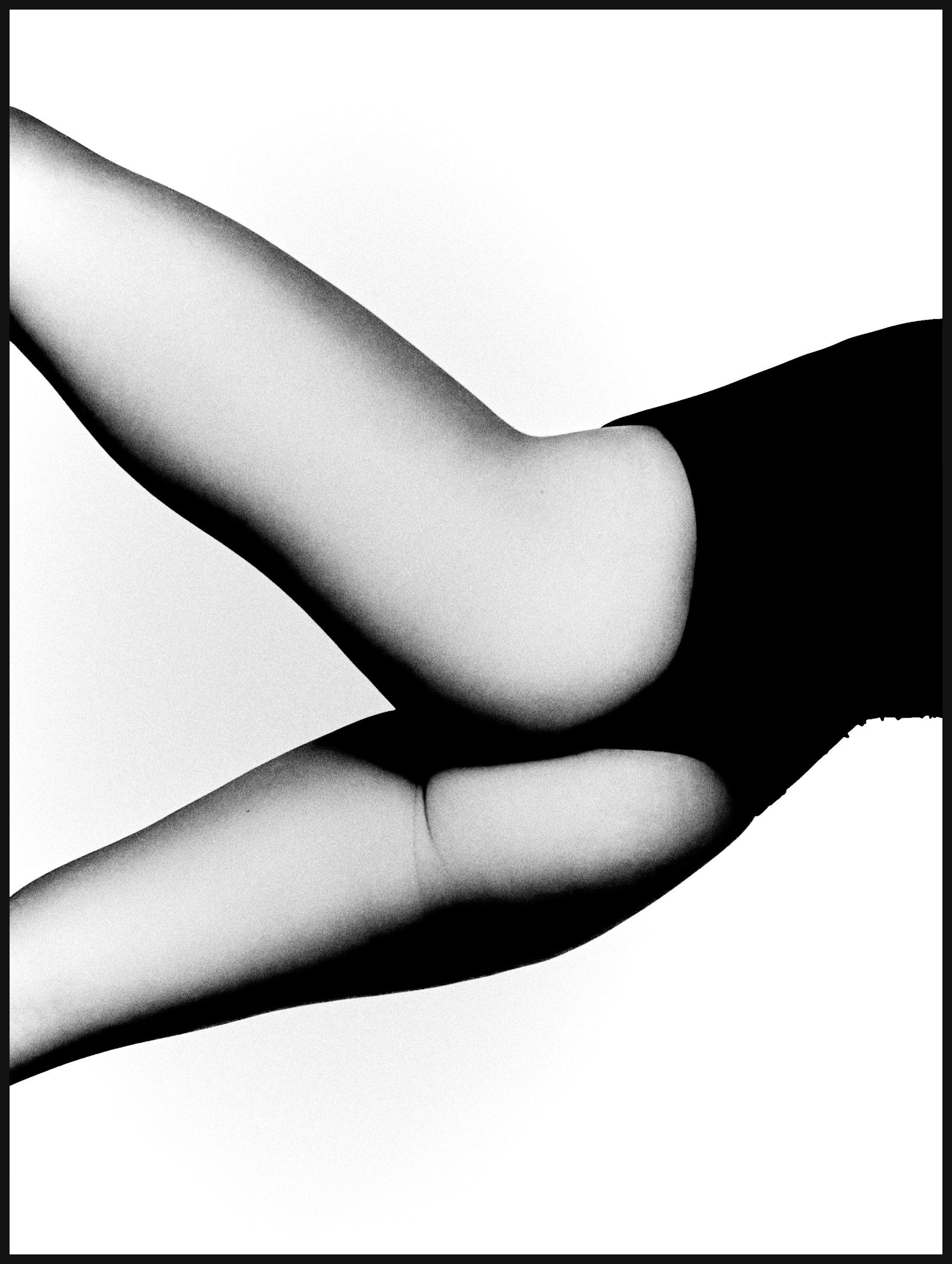 Monochrome study of a curved arm and black fabric