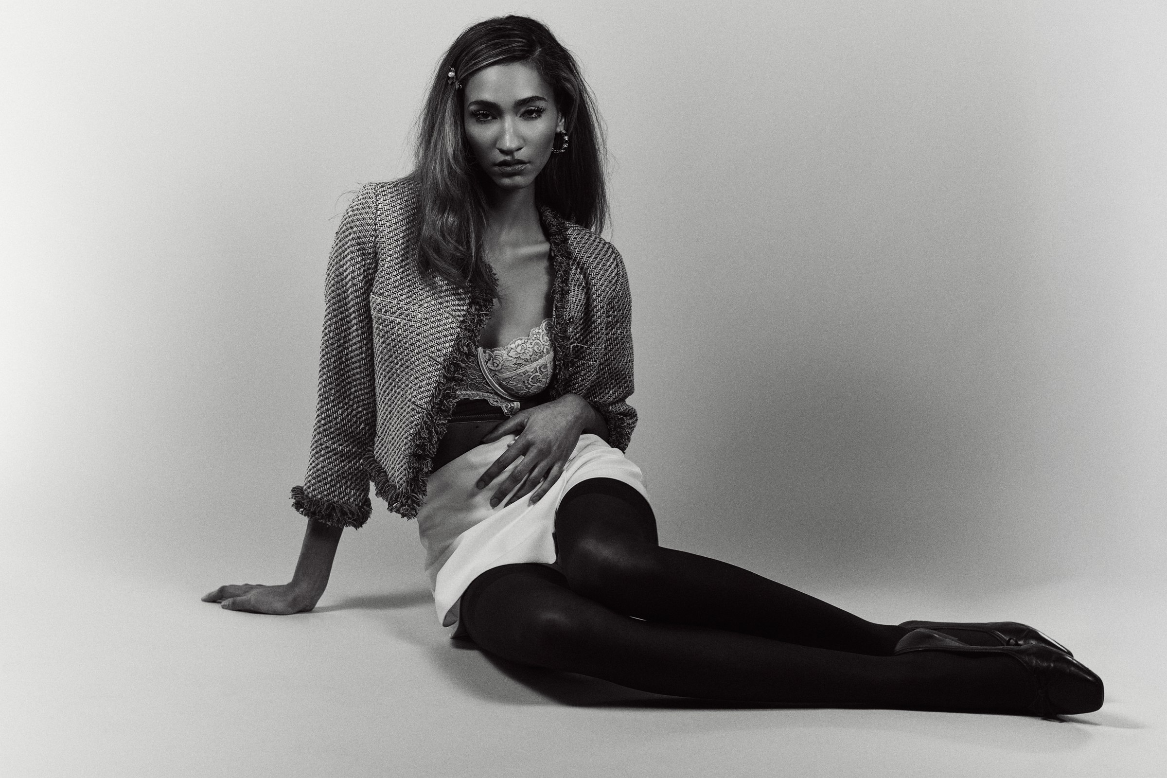 Seated editorial in a cardigan and skirt