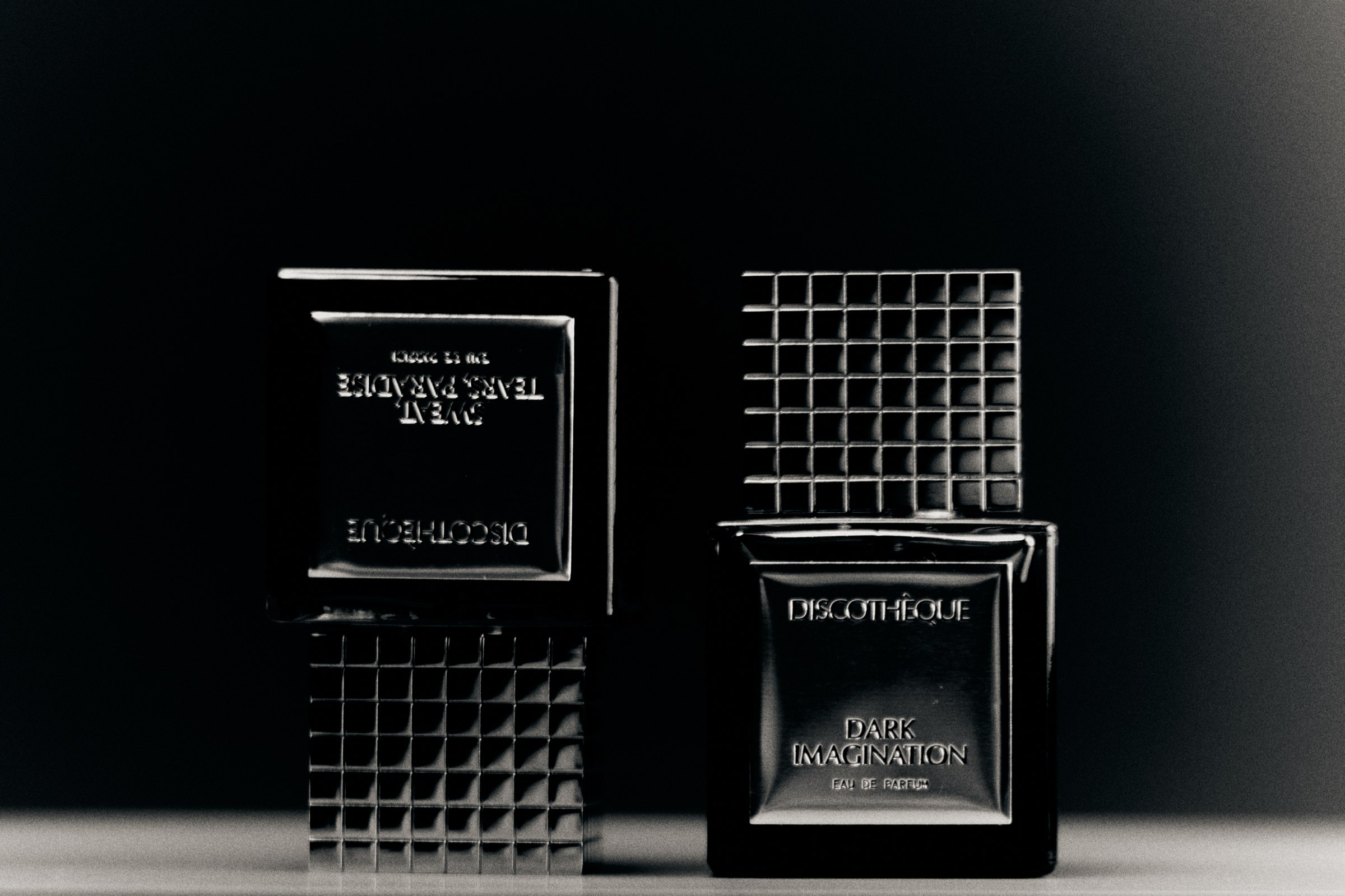 Two perfume bottles in monochrome