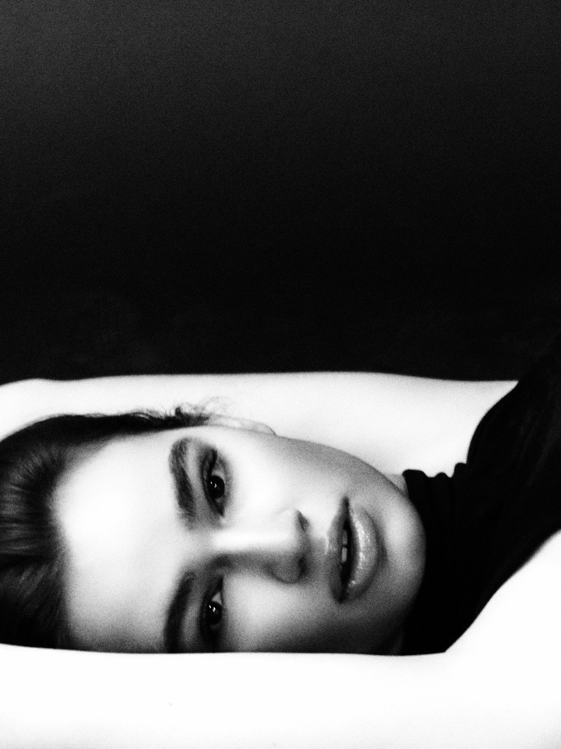 Reclining close portrait in black fabric