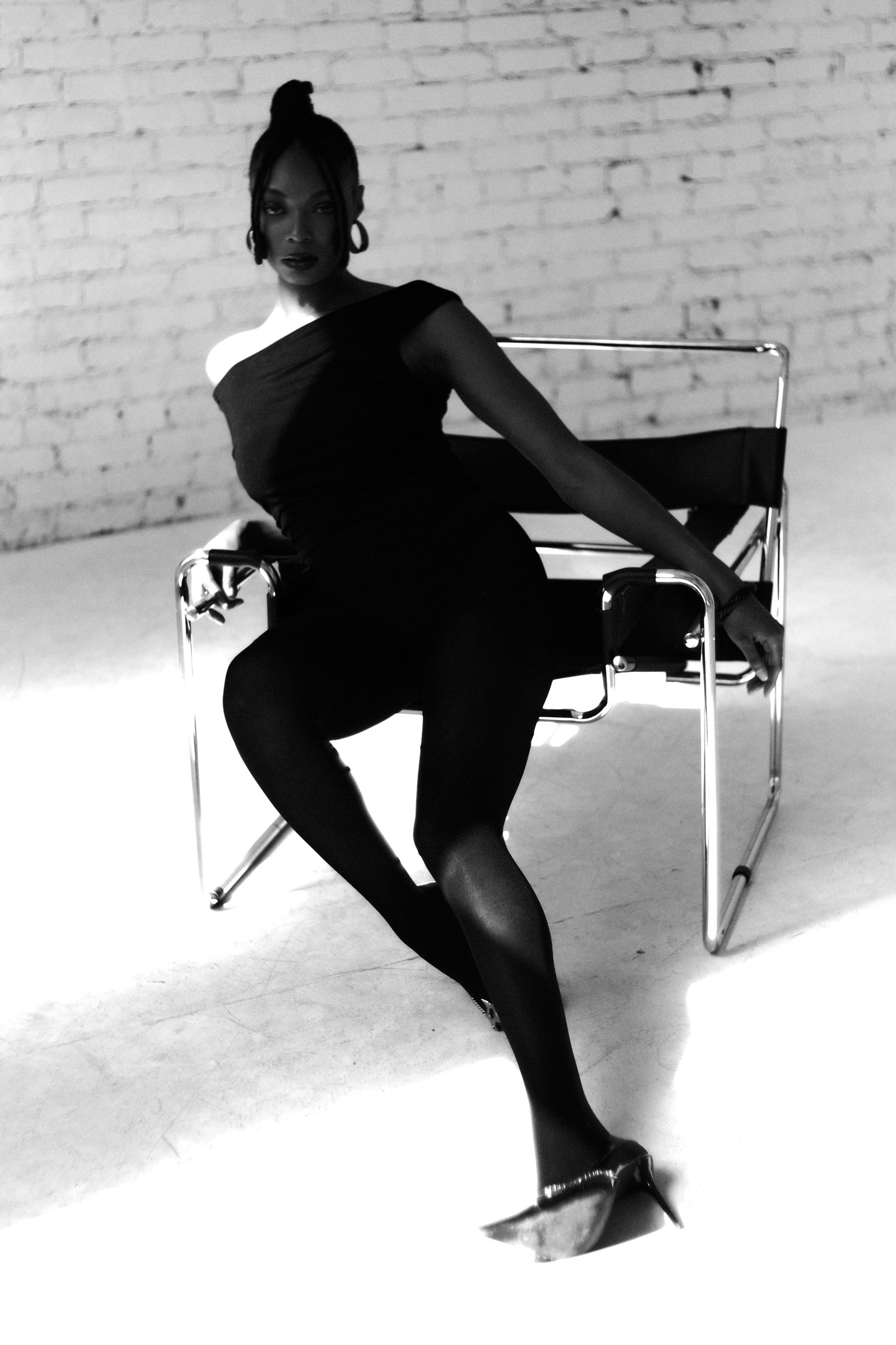 Portrait seated in a chrome chair