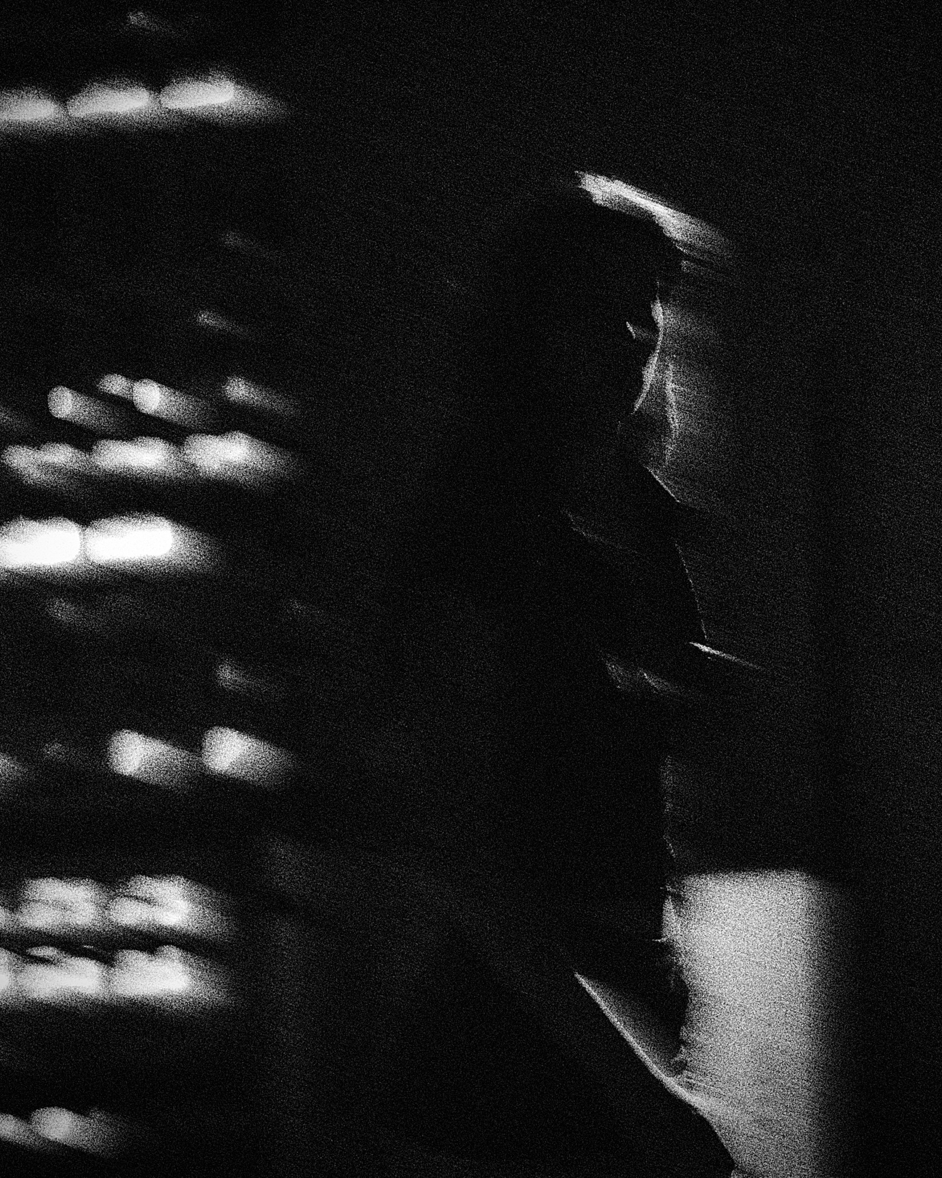 Portrait beneath bands of light