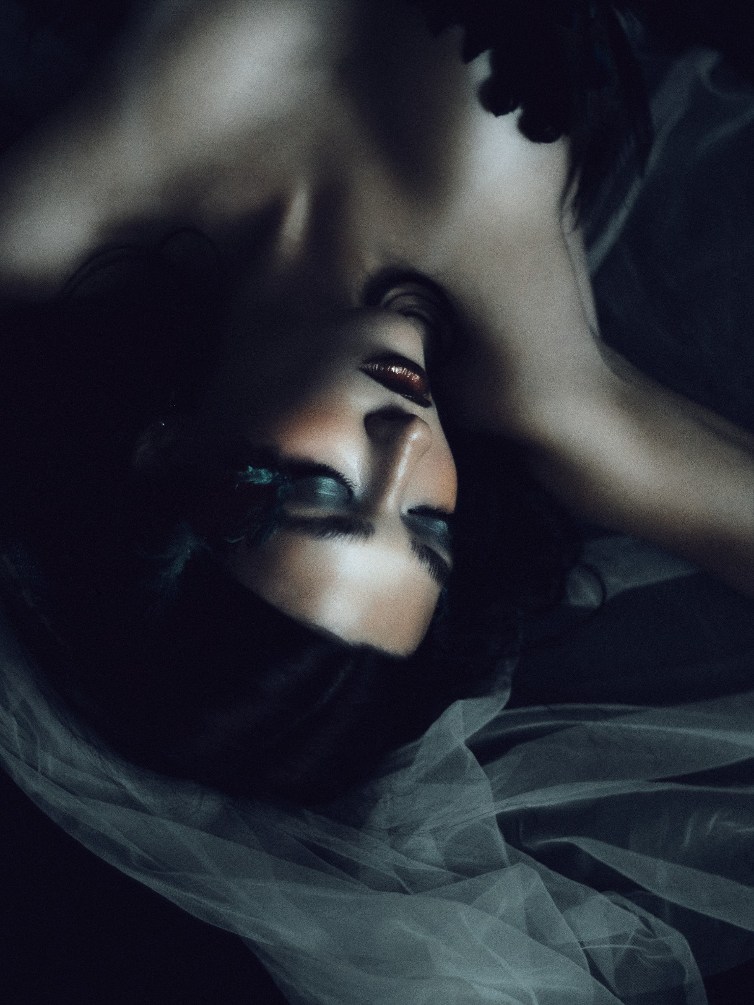 Reclining portrait in soft shadow