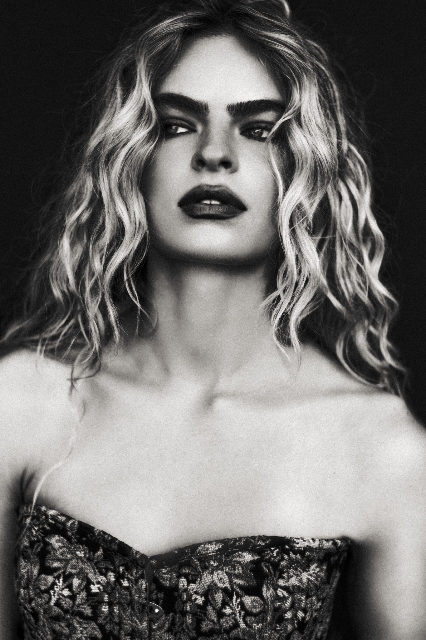Studio portrait in a textured corset