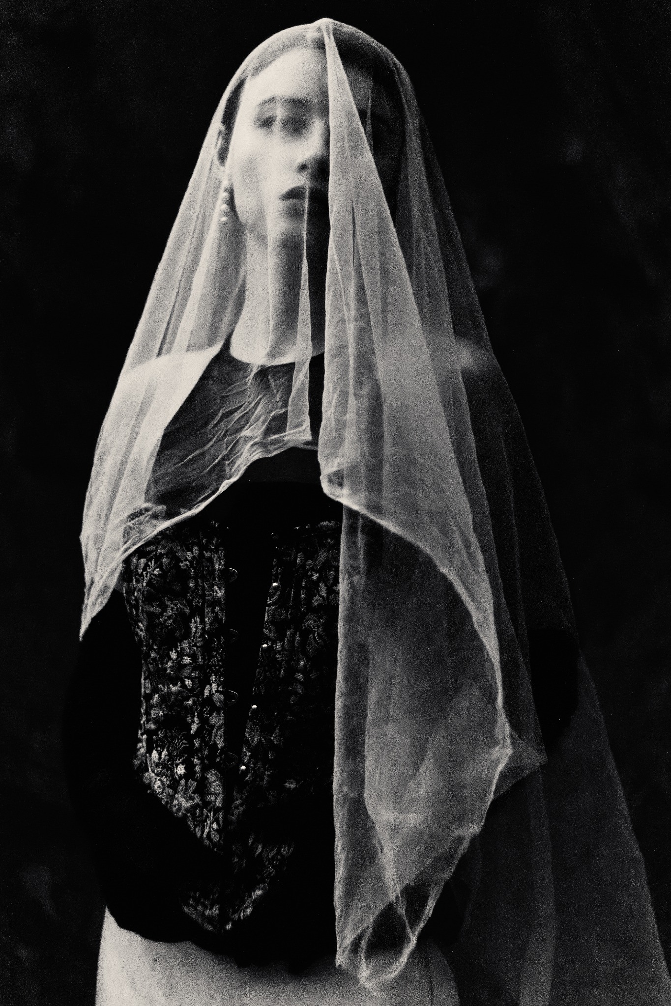 Editorial portrait beneath a translucent veil