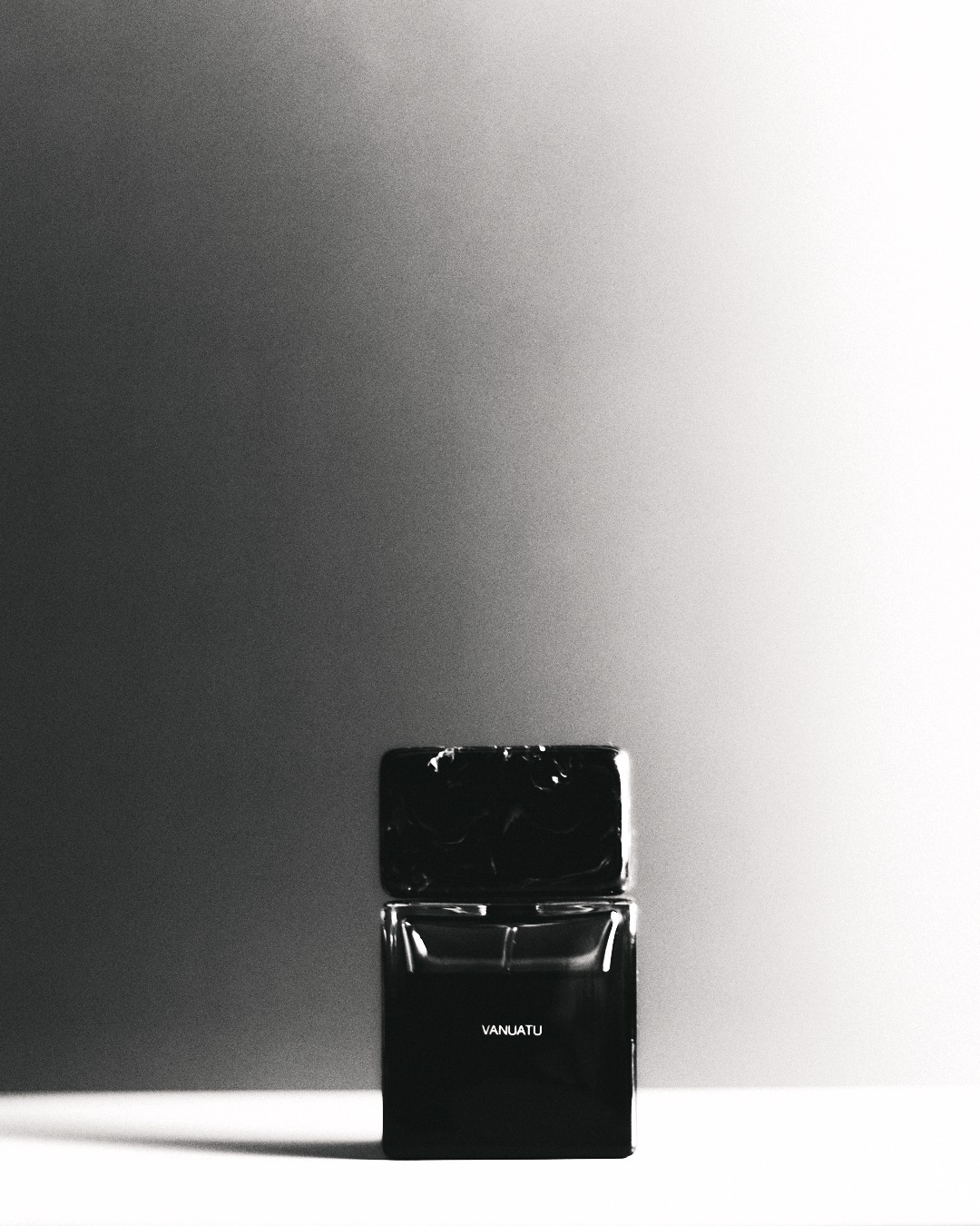 Perfume bottle casting a long shadow