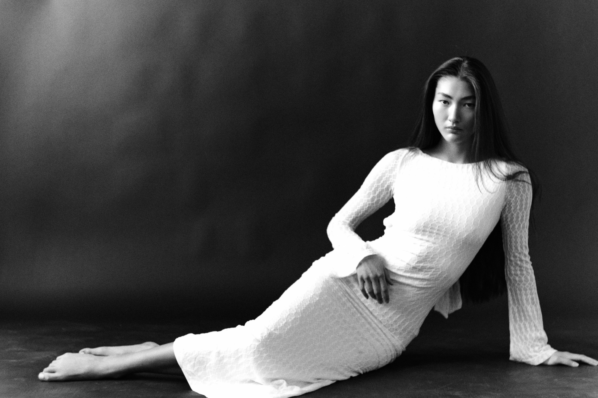Studio editorial with a draped white skirt