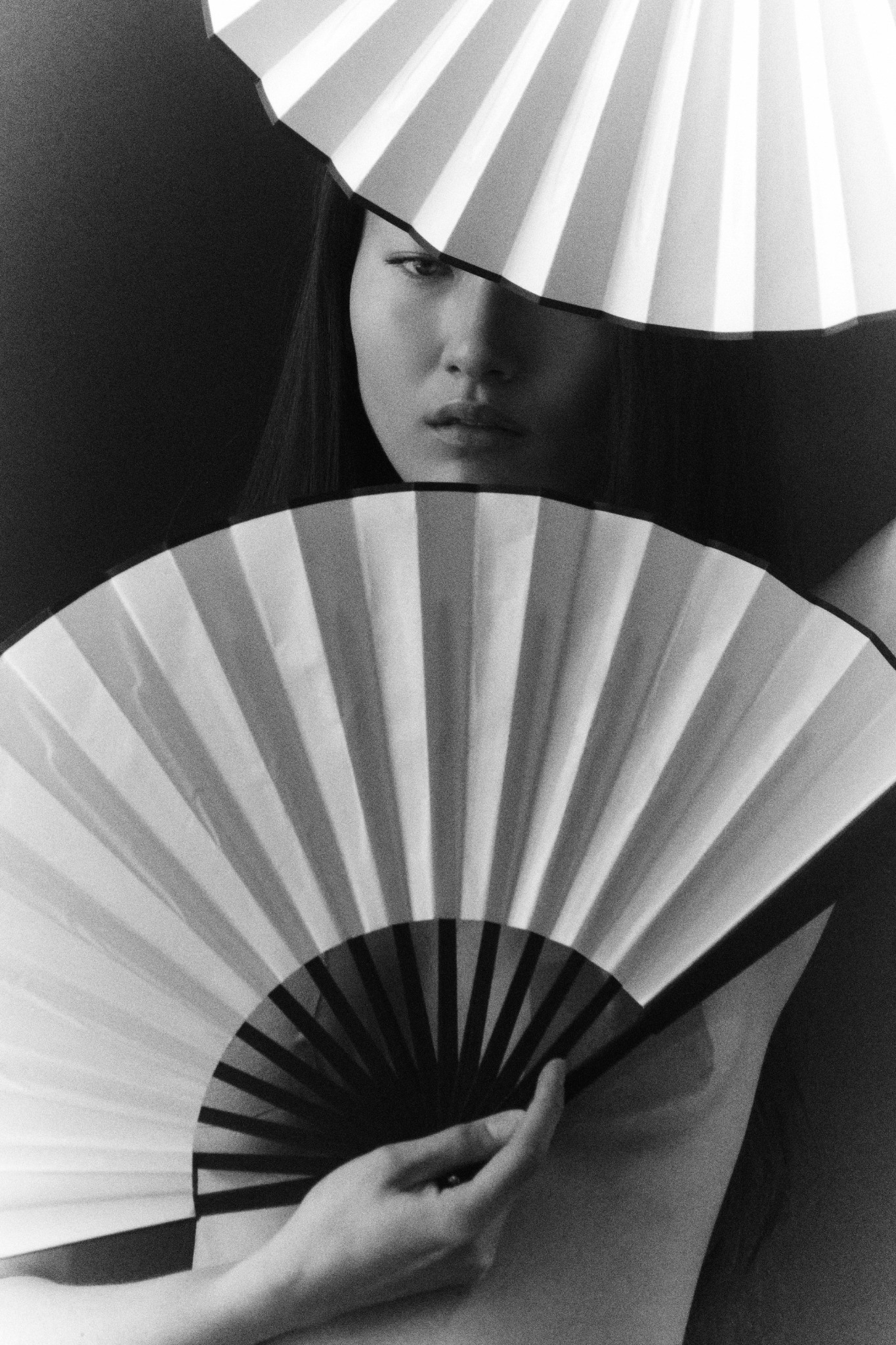 Portrait framed by folded white fans