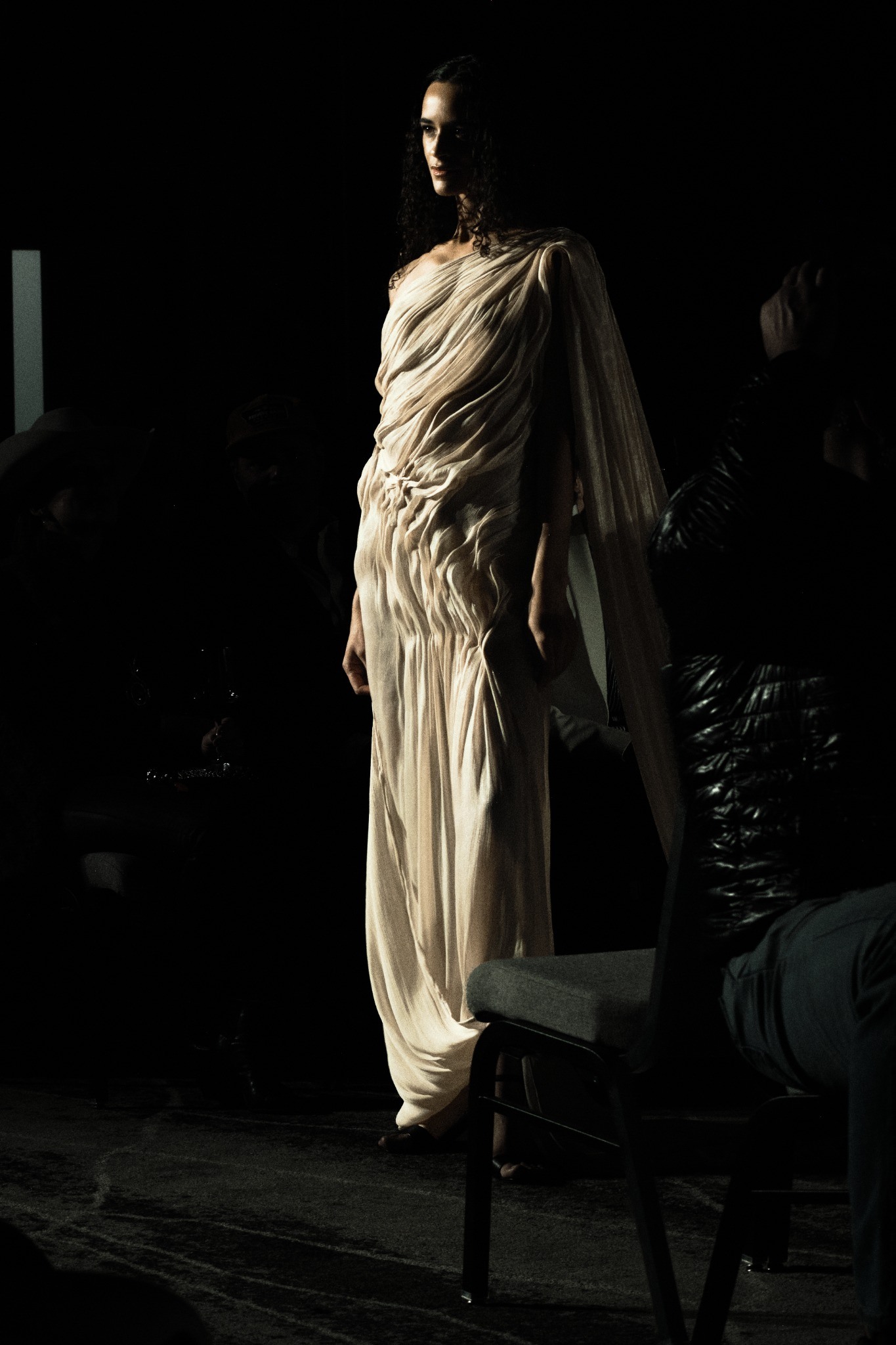 Runway model in a draped light gown