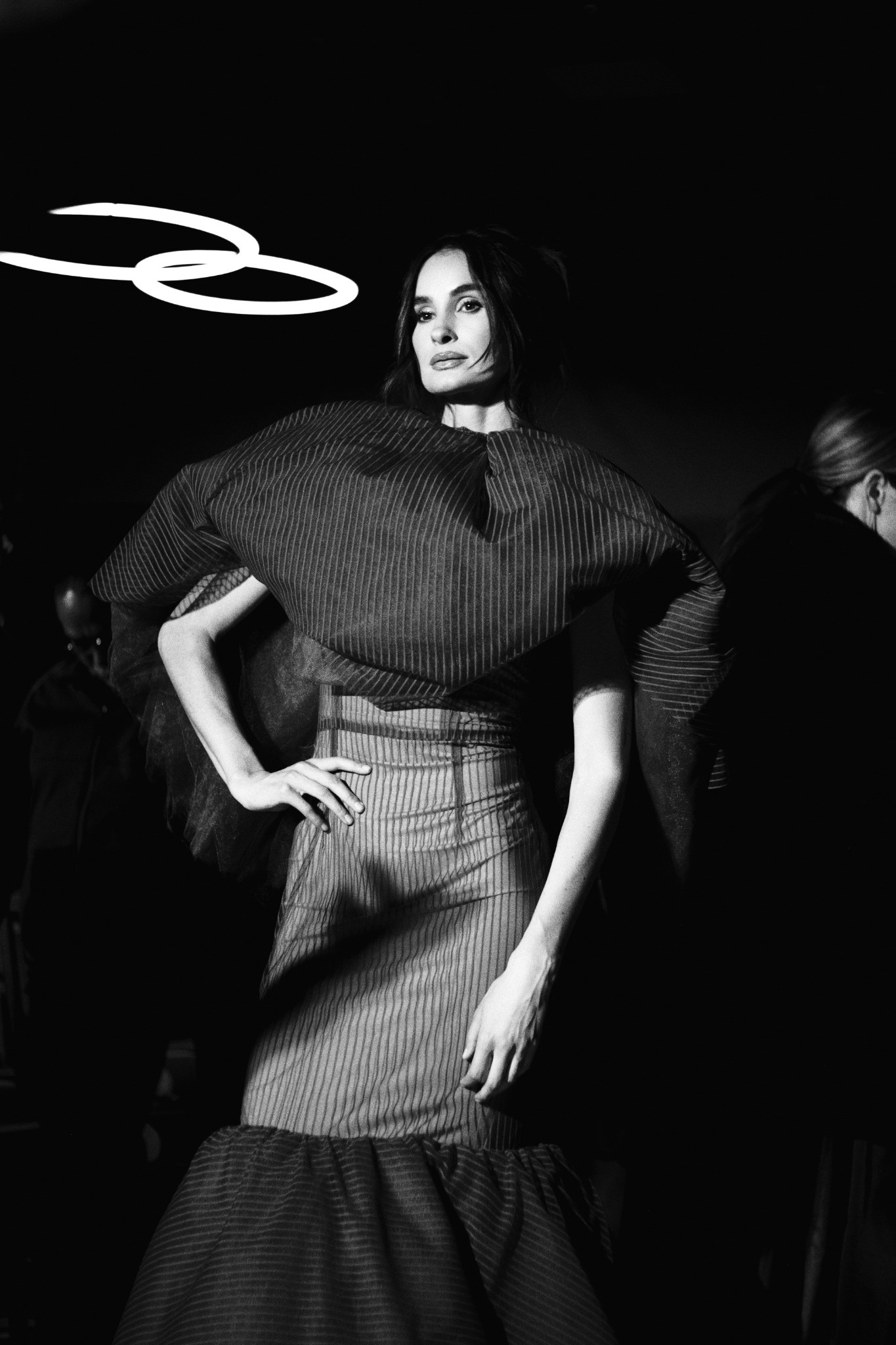 Runway model in a sculptural dark top