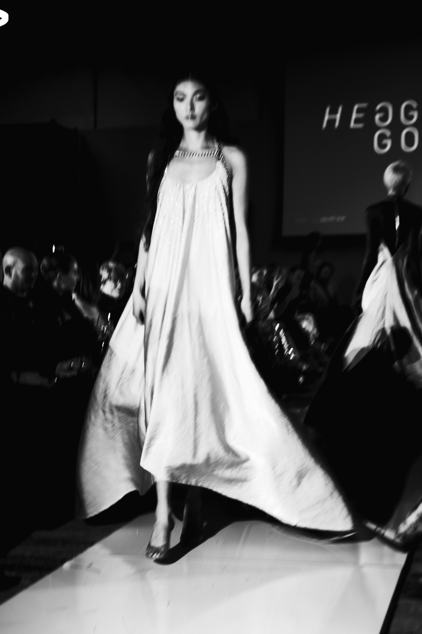 Flowing light runway dress in motion