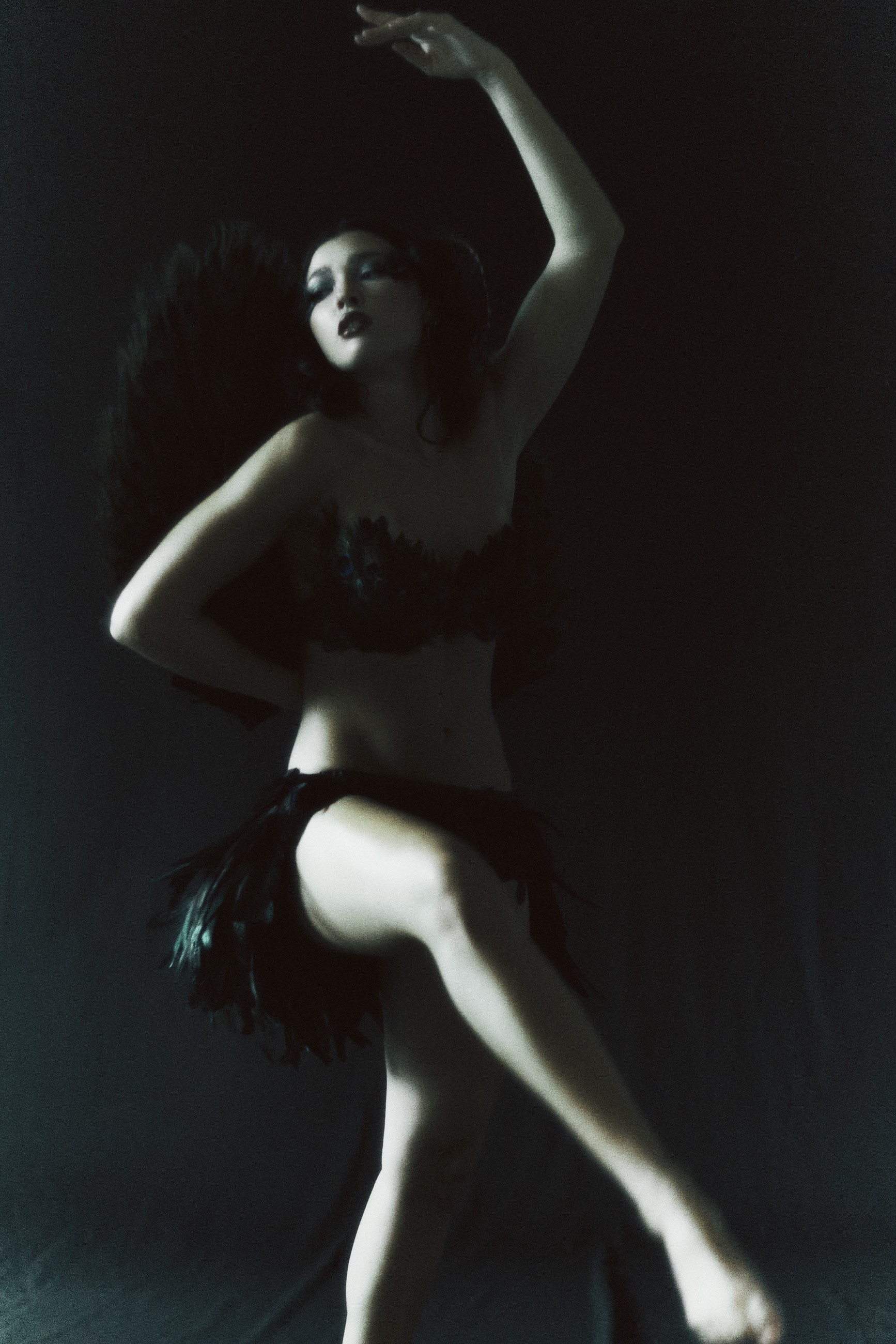 Raised-arm editorial in peacock feathers