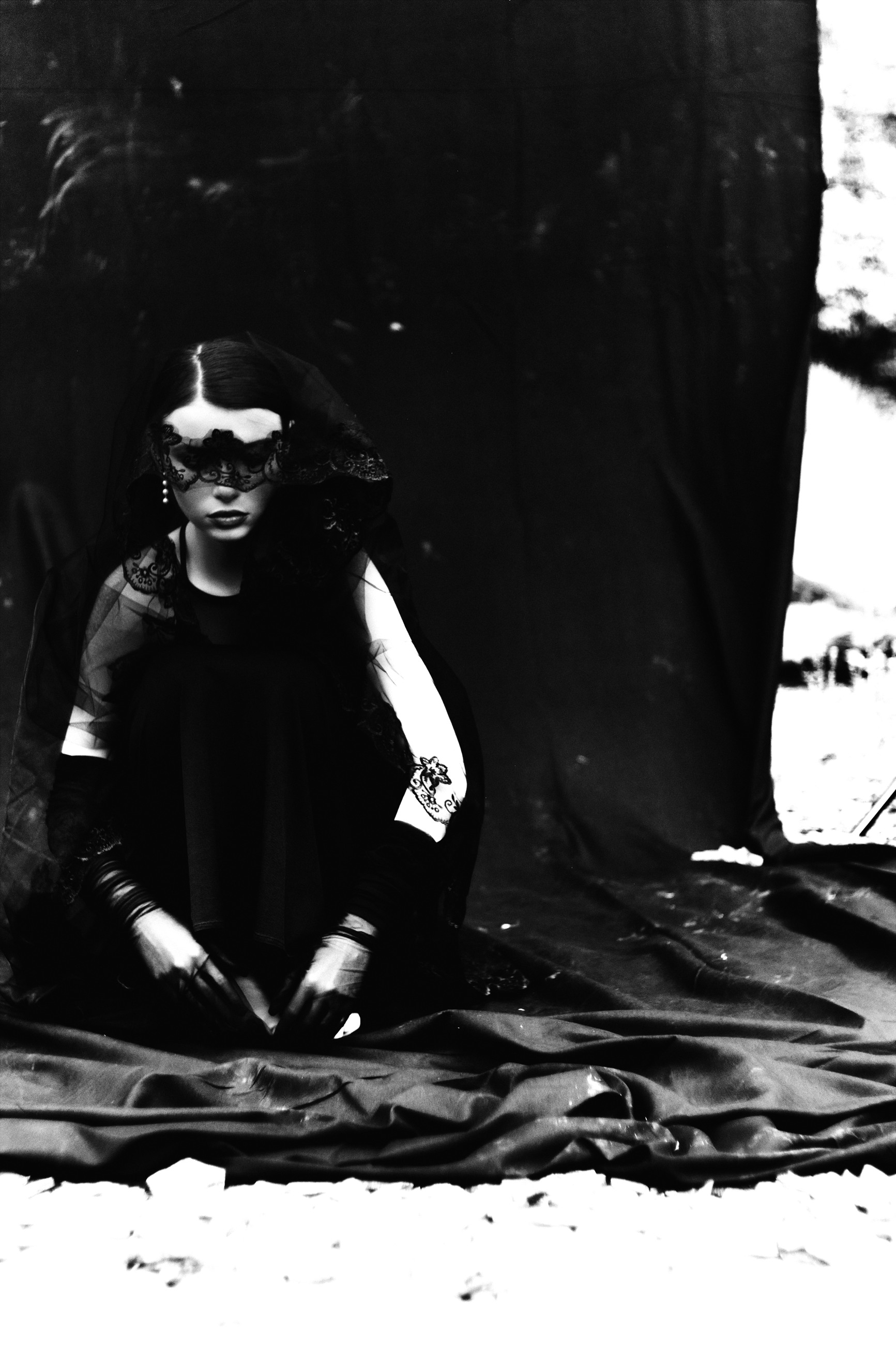 Seated editorial with lace over the eyes